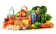 Groceries in wicker basket including vegetables and fruits