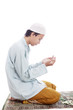 Muslim man worshiping on mat