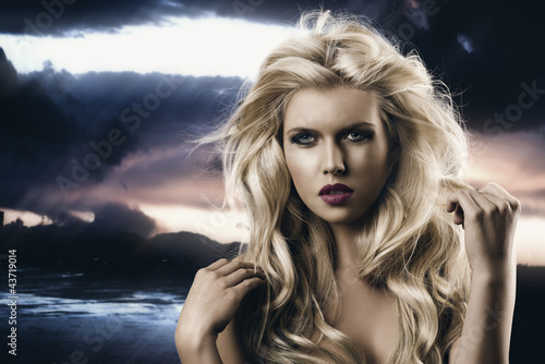 Photo: beauty portrait of blonde girl she is in front of the camera beauty portrait of blonde girl she is in front of the camera