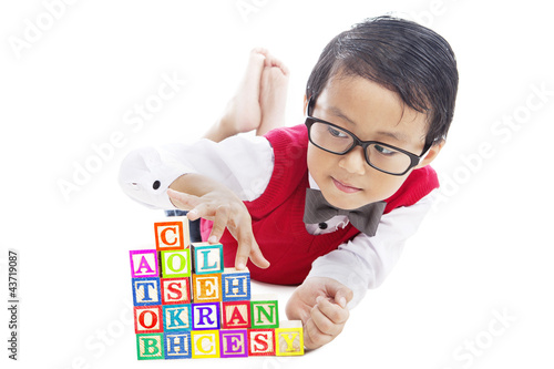 Photo: Schoolboy with alphabet blocks Schoolboy with alphabet blocks