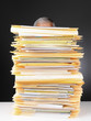 Businessman Behind Stack of Files