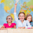 Back to school - elementary school pupil raising hand
