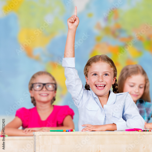 Photo: Back to school - elementary school pupil raising hand Back to school - elementary school pupil raising hand