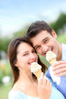 Couple in park eating ice cream cones