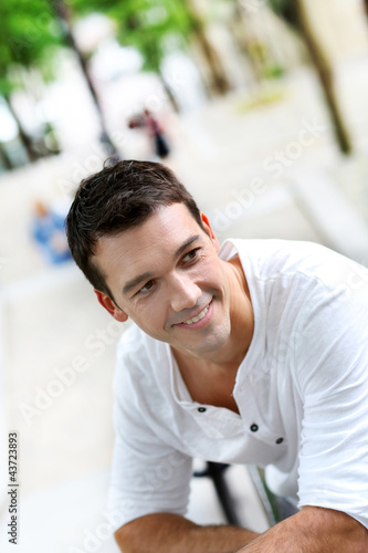 Photo: Portrait of smiling man standing in the street Portrait of smiling man standing in the street
