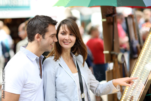 Photo: Couple in Paris looking at restaurant menu Couple in Paris looking at restaurant menu