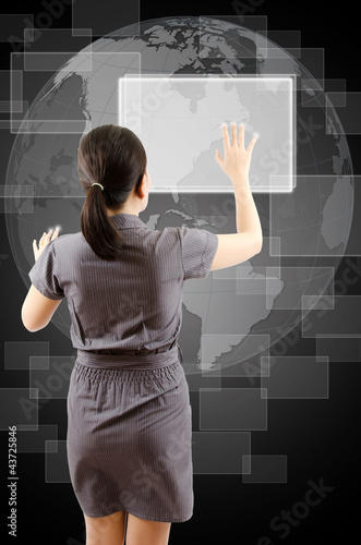 Photo: Business lady pushing digital button on touch screen interface. Business lady pushing digital button on touch screen interface.