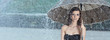 Beautiful  woman holding umbrella out in the rain