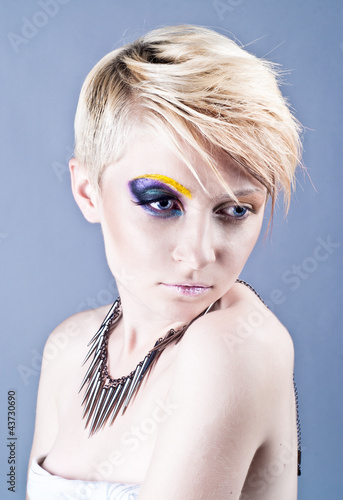 Photo: Beautiful young female with bright impudent make up Beautiful young female with bright impudent make up