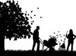 Couple raking leaves in autumn or fall in garden or yard