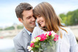 Photo: Portrait of romantic man giving flowers to woman Portrait of romantic man giving flowers to woman