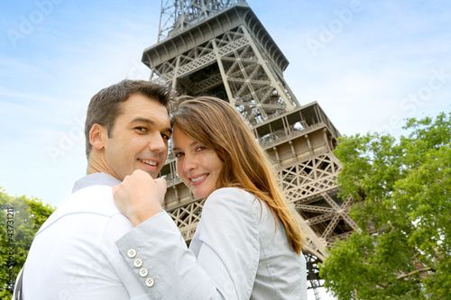 Photo: Couple embracing each other in front of the Eiffel tower Couple embracing each other in front of the Eiffel tower