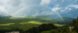 Rainbow in hills. Cloudy day