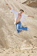 Young man jumping in the sand
