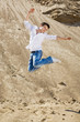 Young man jumping in the sand