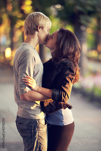 Photo: Young couple kissing on the street Young couple kissing on the street