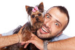 young man holding a cute yorkie puppy dog