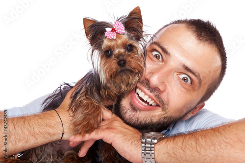 Photo: young man holding a cute yorkie puppy dog young man holding a cute yorkie puppy dog