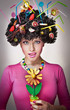 Portrait of a female isolated with lollipops in the hair