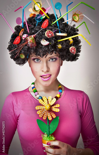Foto: Portrait of a female isolated with lollipops in the hair Portrait of a female isolated with lollipops in the hair