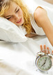 Foto: Blond beautiful woman with alarmclock Blond beautiful woman with alarmclock