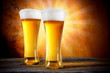 Photo: Beer in a glasses with gold background Beer in a glasses with gold background
