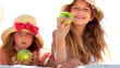 Little girls eating apples