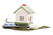 Photo: house sitting with a calculator and dollar house sitting with a calculator and dollar