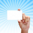 Photo: female hand hold card with blue rays. female hand hold card with blue rays.