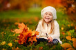 Photo: preschool little girl with autumn leaves in the park preschool little girl with autumn leaves in the park