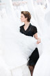 Shop assistant hesitates should the bride try wedding dress