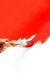Painting with red colored ink and paintbrush on white