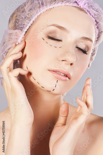 Photo: Beautiful young woman, with perforation lines on her face Beautiful young woman, with perforation lines on her face