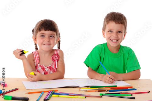 Foto: Two little kids draw with crayons Two little kids draw with crayons