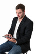 Foto: Young Businessman working on a tablet pc Young Businessman working on a tablet pc