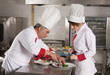 Foto: Two chefs at work in a restaurant Two chefs at work in a restaurant