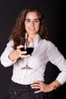 woman holding a glass of wine and smiling