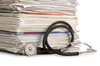 Foto: Stack of papers with stethoscope Stack of papers with stethoscope