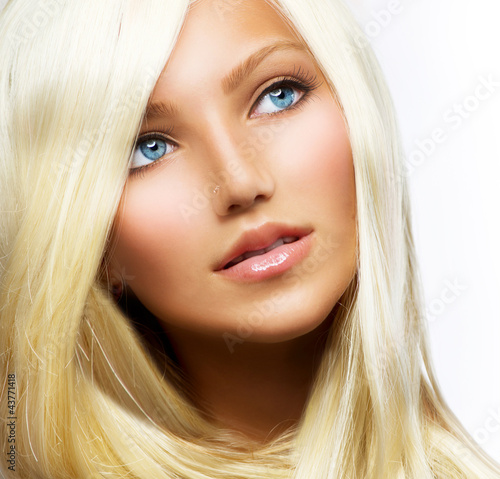 Photo: Beautiful Blond Girl isolated on a White Background Beautiful Blond Girl isolated on a White Background