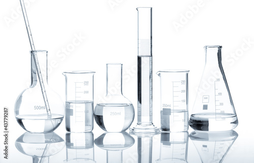 Photo: Group of laboratory flasks with a clear liquid, isolated Group of laboratory flasks with a clear liquid, isolated
