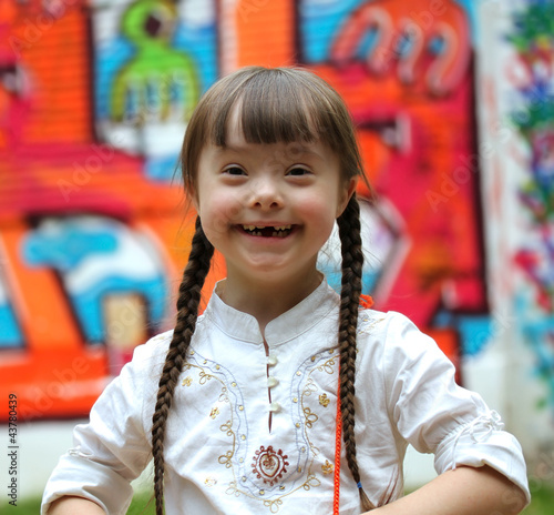 Photo: Portrait of beautiful young happy girl on playground. Portrait of beautiful young happy girl on playground.