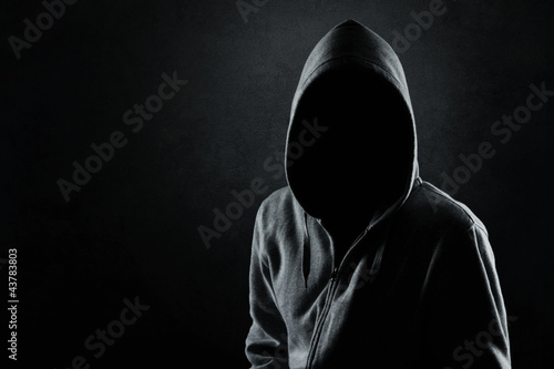Photo: Silhouette of hooded man or hooligan Silhouette of hooded man or hooligan
