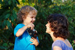 Young smiling photographer with a camera shoots her mother
