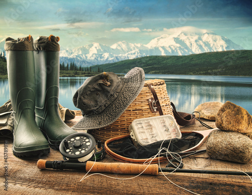 Photo: Fly fishing equipment on deck with view of a lake and mountains Fly fishing equipment on deck with view of a lake and mountains