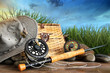 Foto: Fly fishing equipment with hat on wooden dock Fly fishing equipment with hat on wooden dock