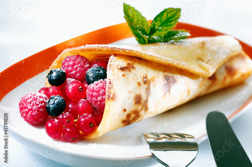 Photo: Golden pancake filled with berries Golden pancake filled with berries