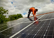 Electrician checking solar panels on roof