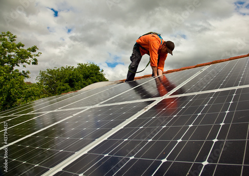 Photo: Electrician checking solar panels on roof Electrician checking solar panels on roof