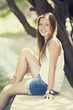 Foto: Teen girl near lake in the park. Teen girl near lake in the park.