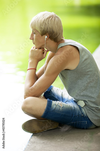 Foto: Teen boy with headphones at park Teen boy with headphones at park